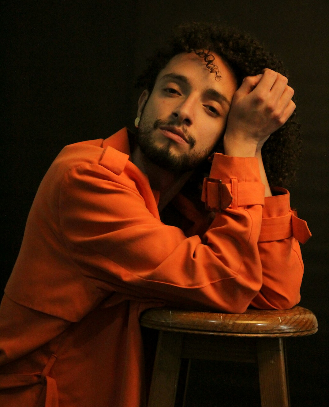 Studio portrait of a young mexican man with curly hair