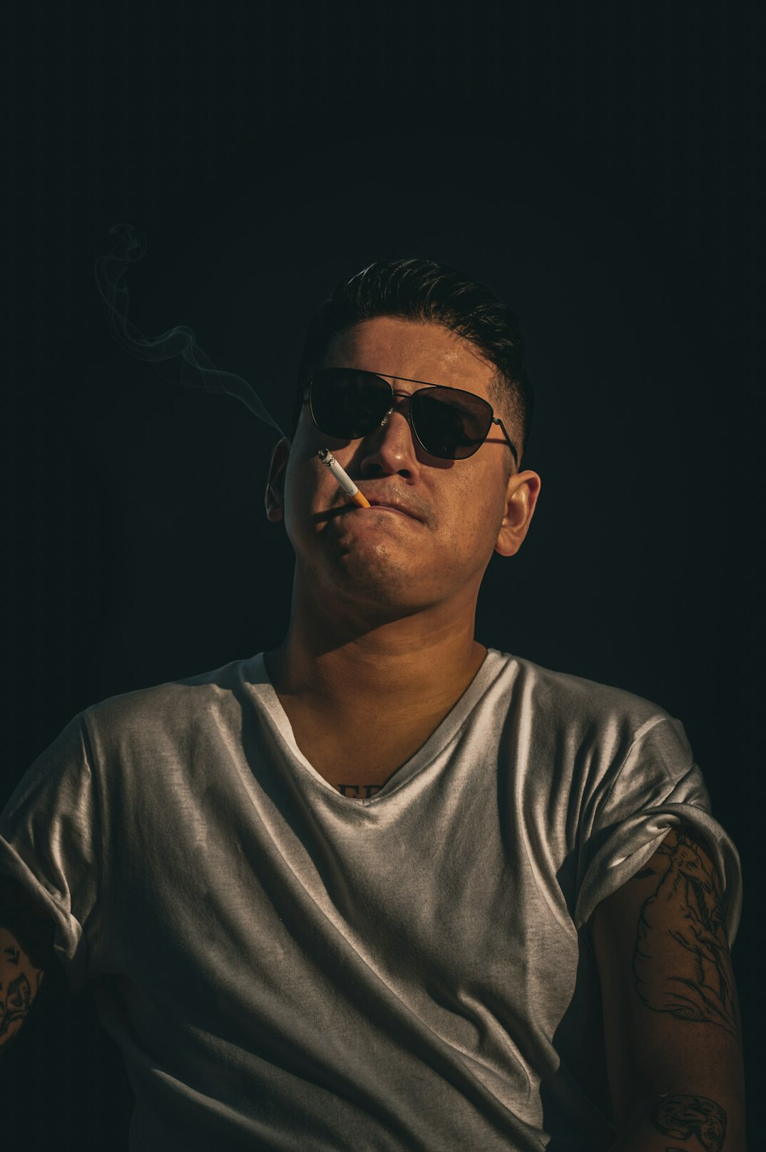 Studio portrait of a mexican man with glasses