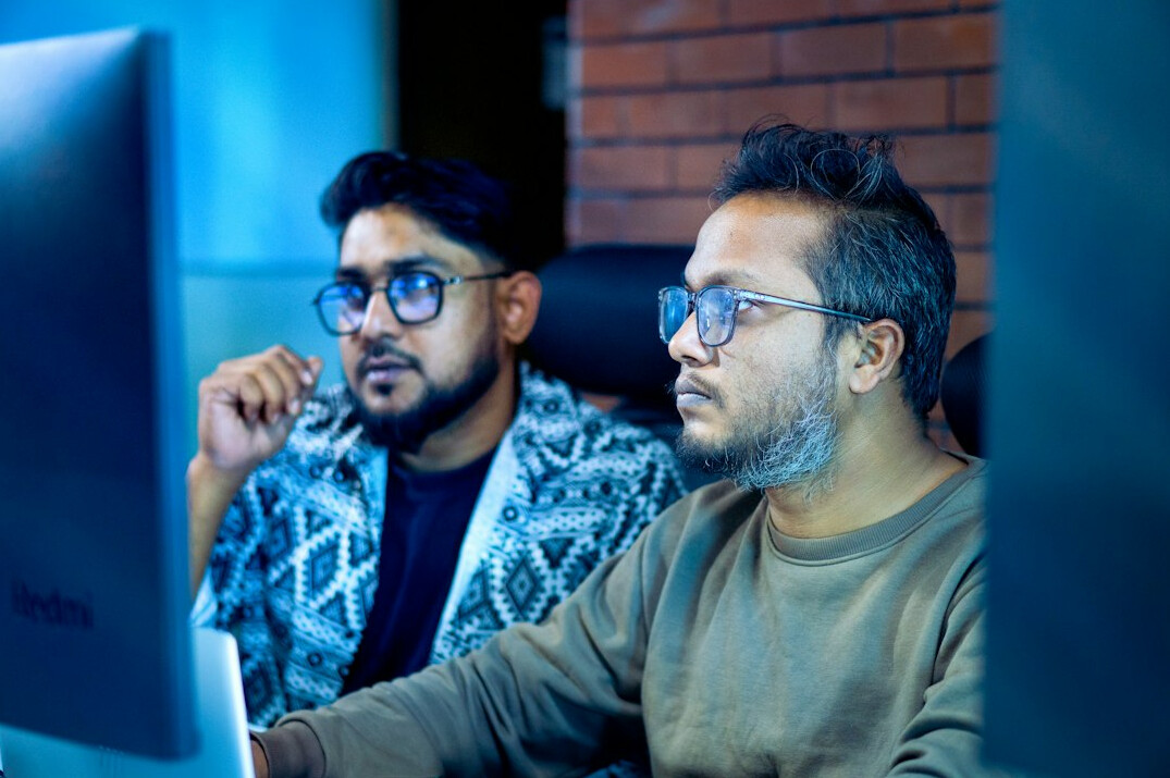 team of developers coding in office